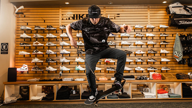 Ty Martinez ollies a skateboard while juggling a golf ball in their golf shop at Keeton Park Golf Course. (Photo by Ryan Lochhead)