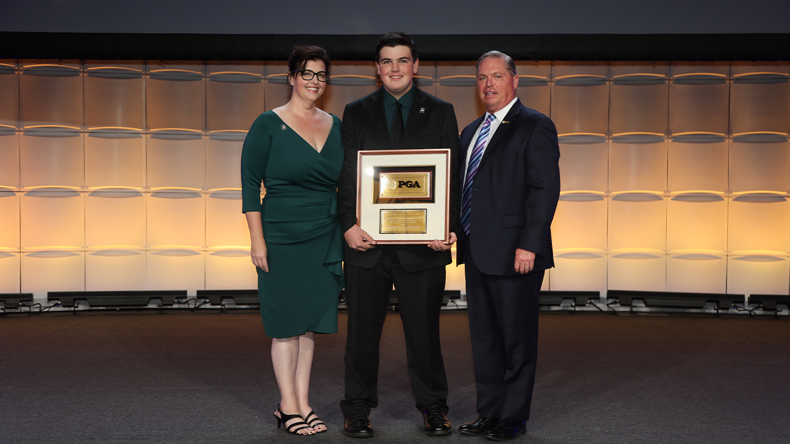 PGA of America President, Jim Richerson pose for a photo with Jill and Jackson Beckwith during the PGA Special Awards night for the 106th PGA Annual Meeting at JW Marriott Phoenix Desert Ridge Resort & Spa on Tuesday, November 1, 2022 in Phoenix, Arizona. (Photo by Sam Greenwood/PGA of America)