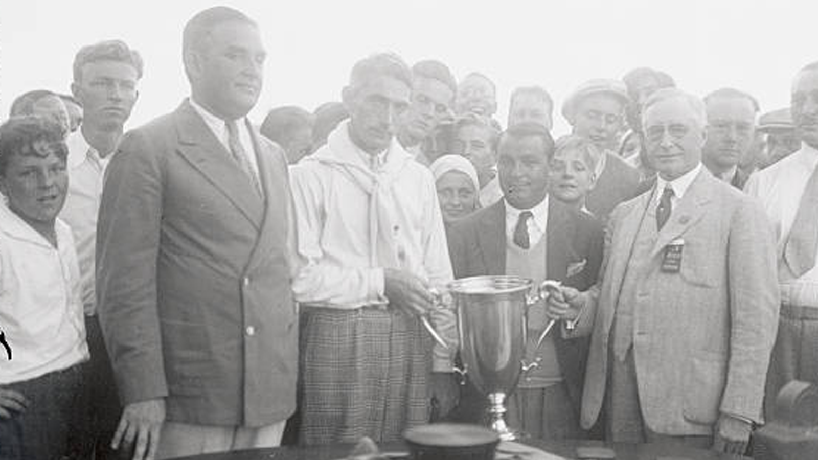 Left to right: Benjamin Ribman, President of Fresh Meadow, Tommy Armour, Champion, Gene Sarazen, Runner-Up, Albert Gates, PGA Business Manager, and the Perpetual Championship Cup.