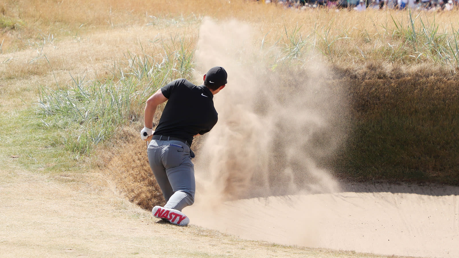 Rory McIlroy of N. Ireland hits his second shot from a bunker on the first hole during the first round of the 147th Open Championship at Carnoustie Golf Club on July 19, 2018 in Carnoustie, Scotland. (Photo by Francois Nel, Getty Images)
