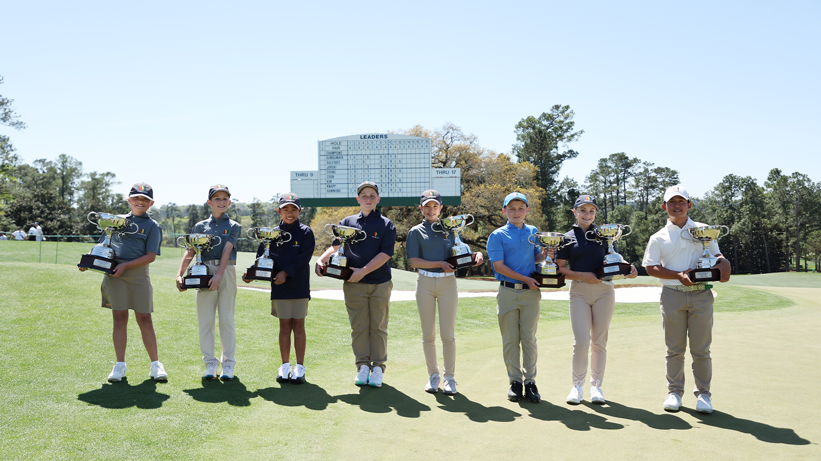 The overall winners pose for a photo on the 18th green after the Drive, Chip and Putt Championship at Augusta National Golf Club on April 03, 2022 in Augusta, Georgia. (Photo by Gregory Shamus/Getty Images)
