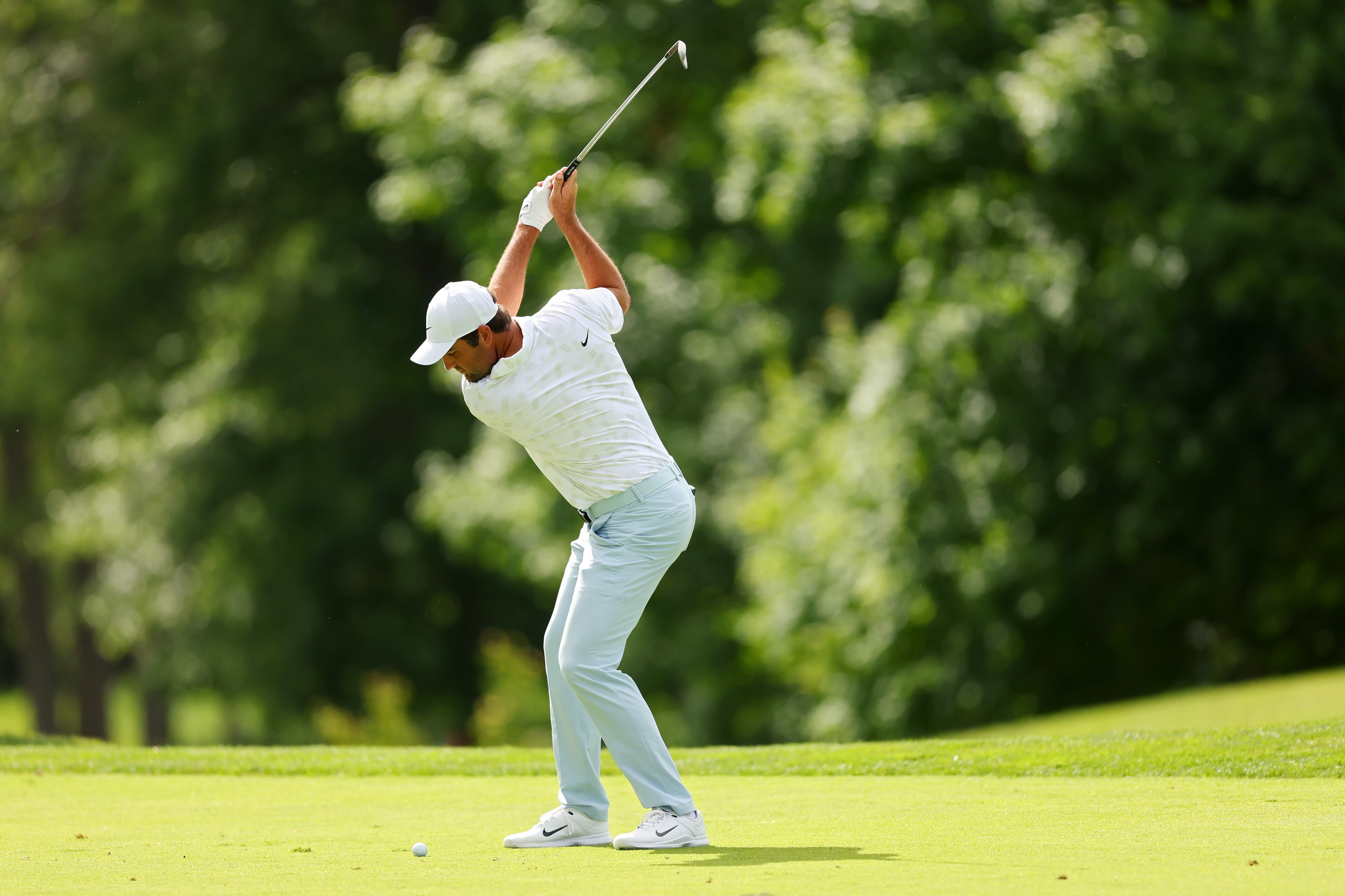 Scheffler maintains the same posture through his entire swing.