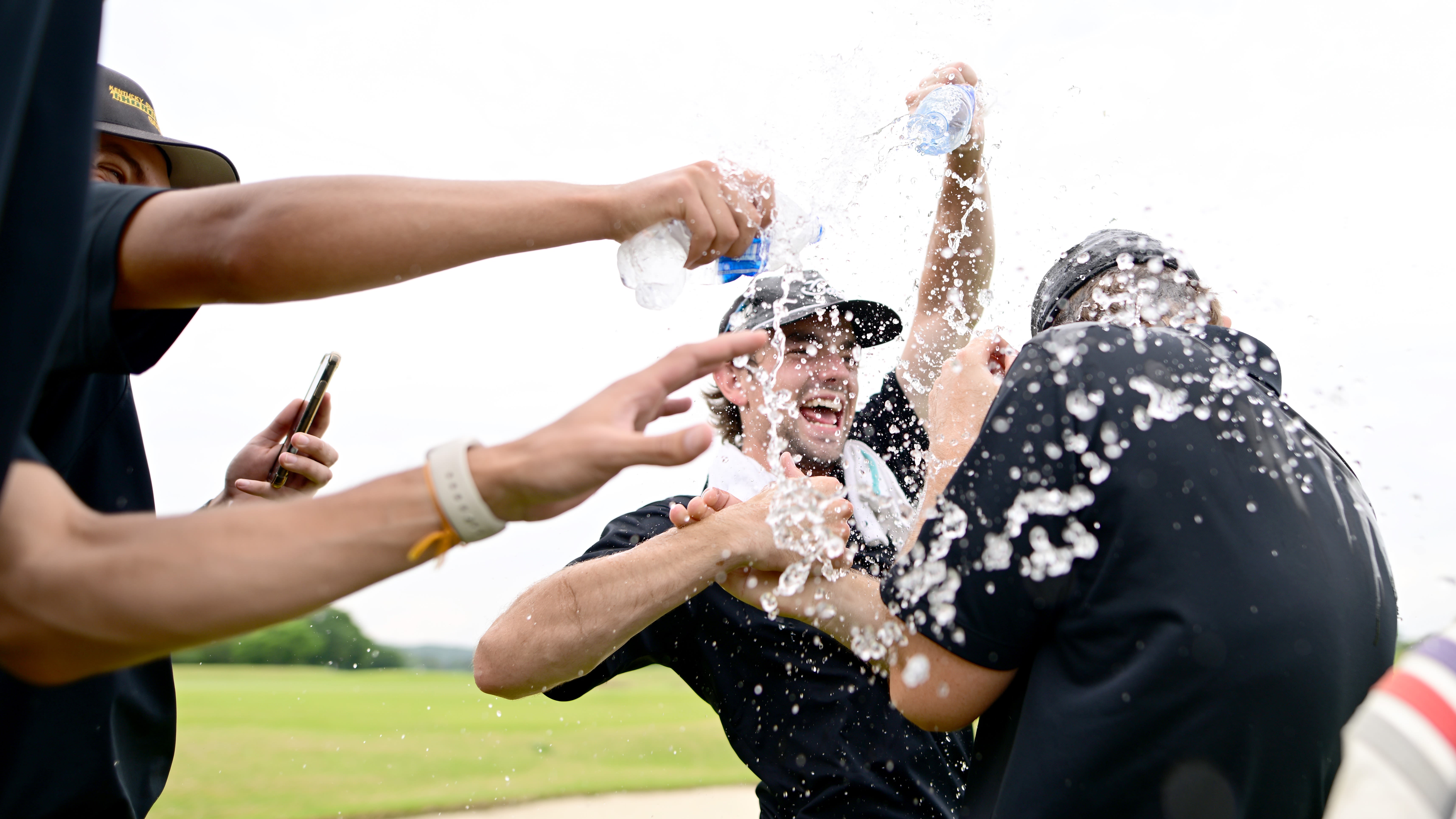 Participants of Kentucky State University dump water on Micah Stangebye during the final round of the 2023 PGA WORKS Collegiate Championship.