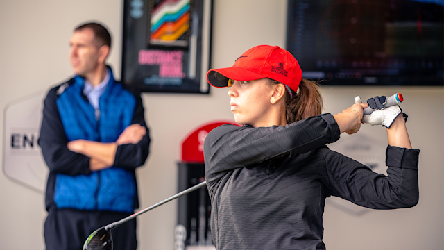 A customer hits a shot while being fitted for a new driver at Windmill Golf Center.