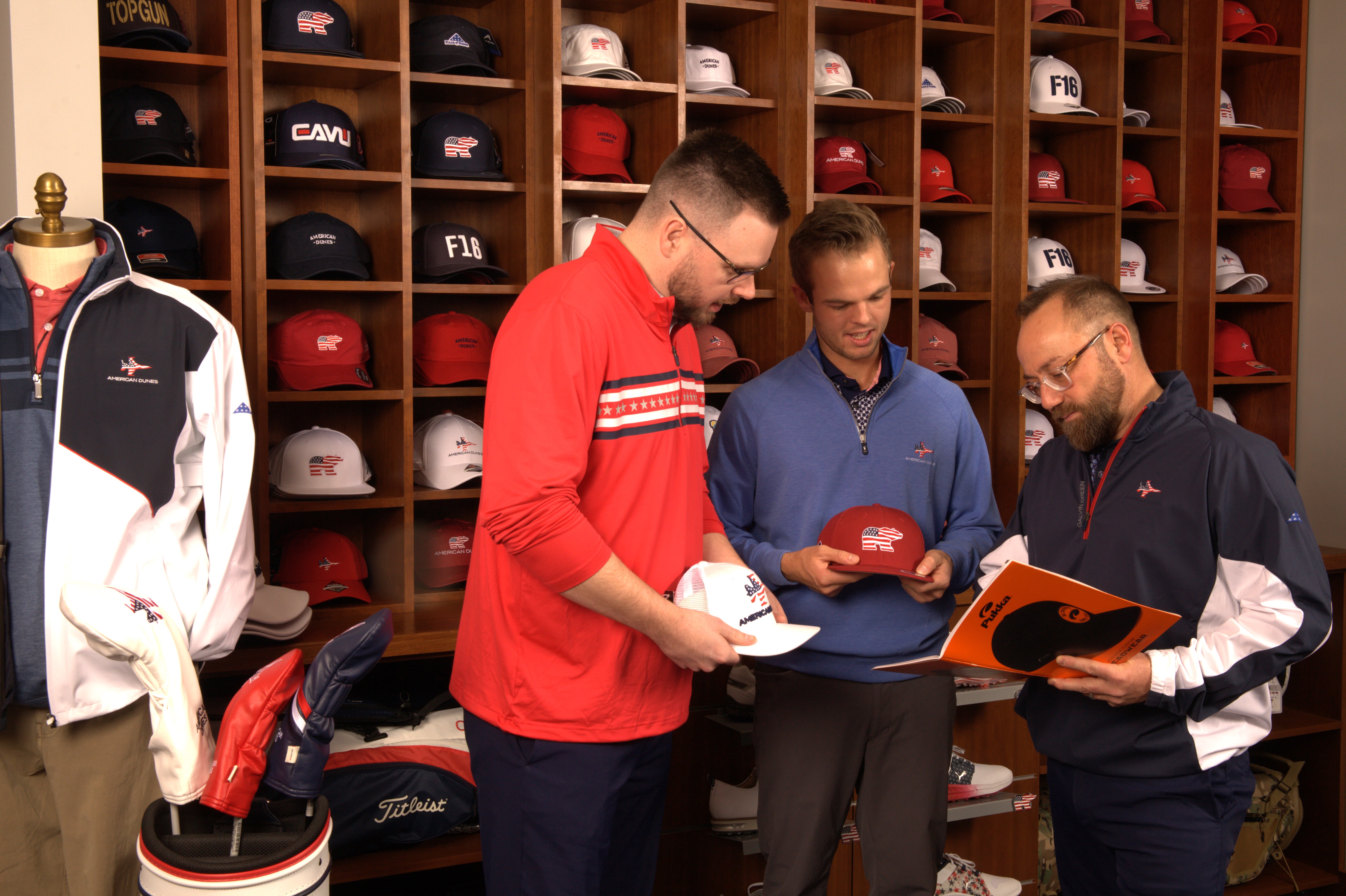 Ziska (far right) and PGA Associates Stone Whipple (left) and Cooper Bell proudly feature red, white and blue in many of their golf shop offerings.