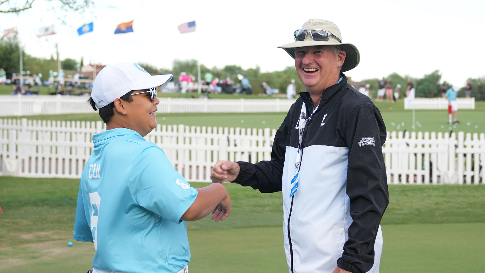 William Cui of Team Illinois talks with Coach Kevin Weeks, PGA, during the first round of the 2022 National Car Rental PGA Jr. League Championship. (Photo by Darren Carroll/PGA of America)