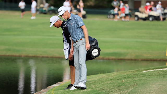 Will Zalatoris of the United States talks with his caddie on the third playoff hole on the 11th green after his ball went in the water during the final round of the FedEx St. Jude Championship at TPC Southwind on August 14, 2022 in Memphis, Tennessee. (Photo by Andy Lyons/Getty Images)