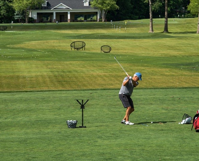 A Sycamore Hills member tests out a new wedge at the club's practice facility during a past Vokey Wedge Experience. 