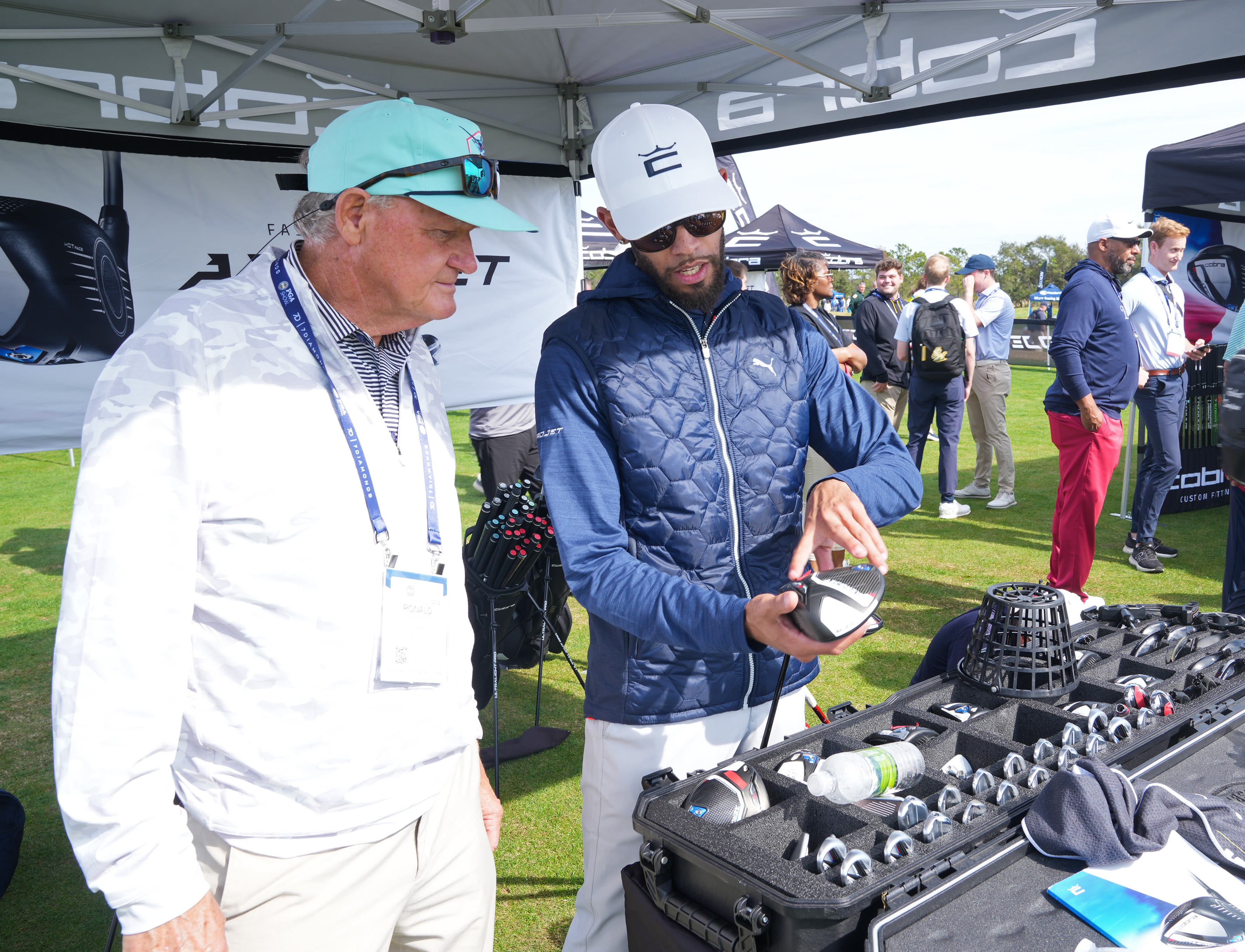 A Demo & Fitting Day attendee learns more about the Aerojet woods during a visit to the Cobra Golf area at Orange County National Golf Center on Jan. 24, 2023 in Orlando, Florida. (Photo by Darren Carroll/PGA of America)