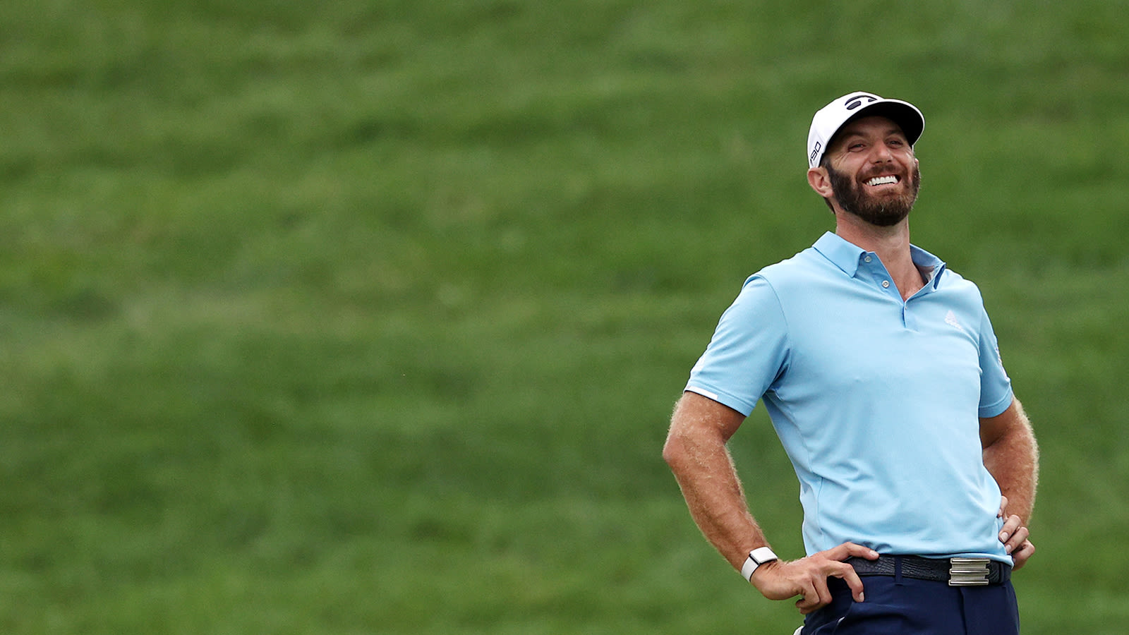 Dustin Johnson of the United States reacts after making a putt for par on t...