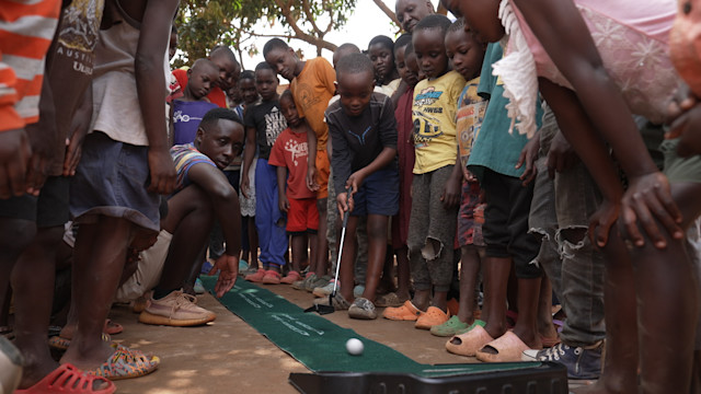 Roger Sali (center) shares his love for golf with all ages of Ugandans. (Photo courtesy of PGA TOUR)