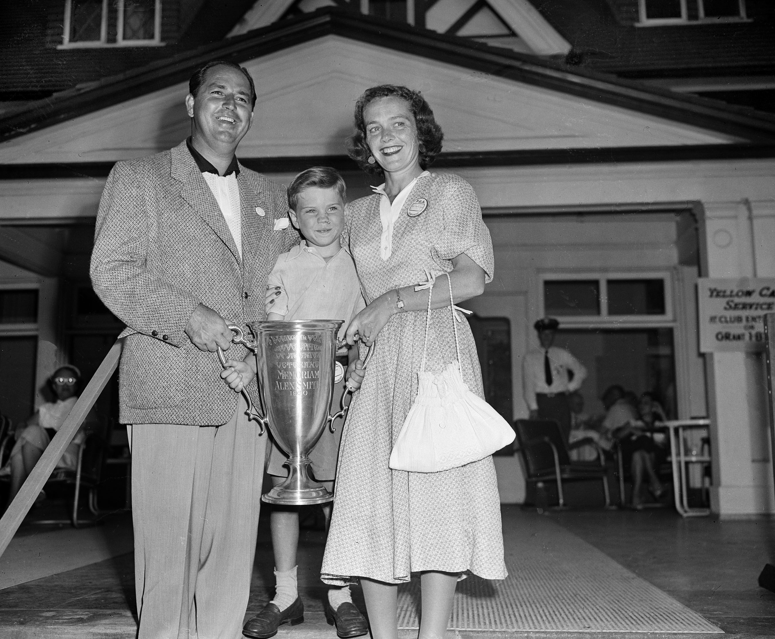 1951 Medalist, Claude Harmon celebrating with son Butch and bride Alice at Oakmont Country Club.