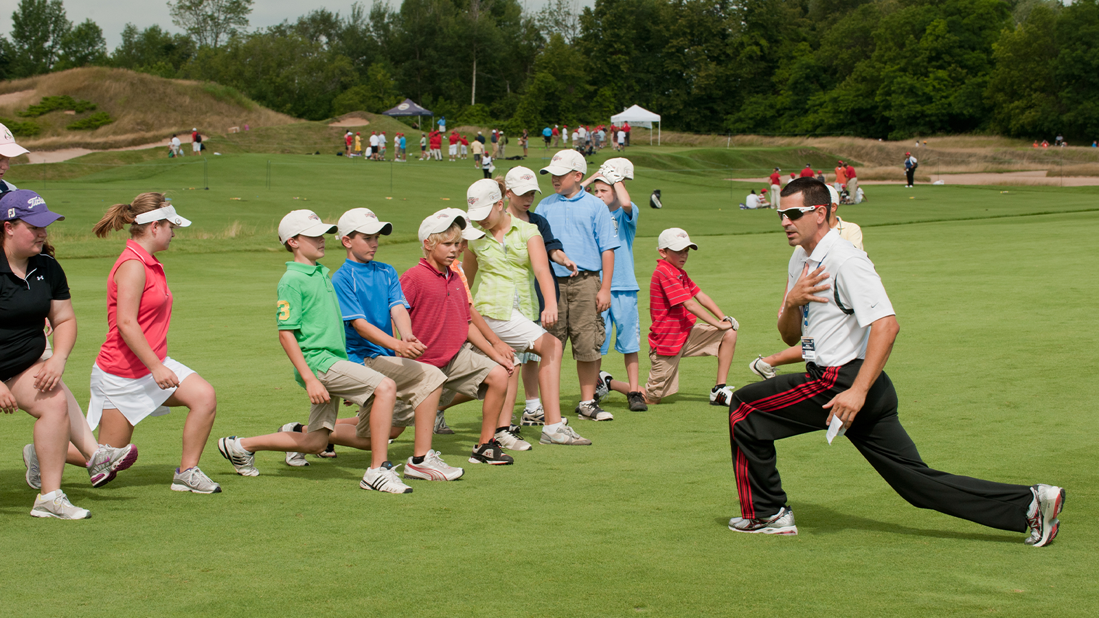 David Donatucci works with Juniors on exercises during a Youth Clinic. (Photo by Montana Pritchard/The PGA of America)