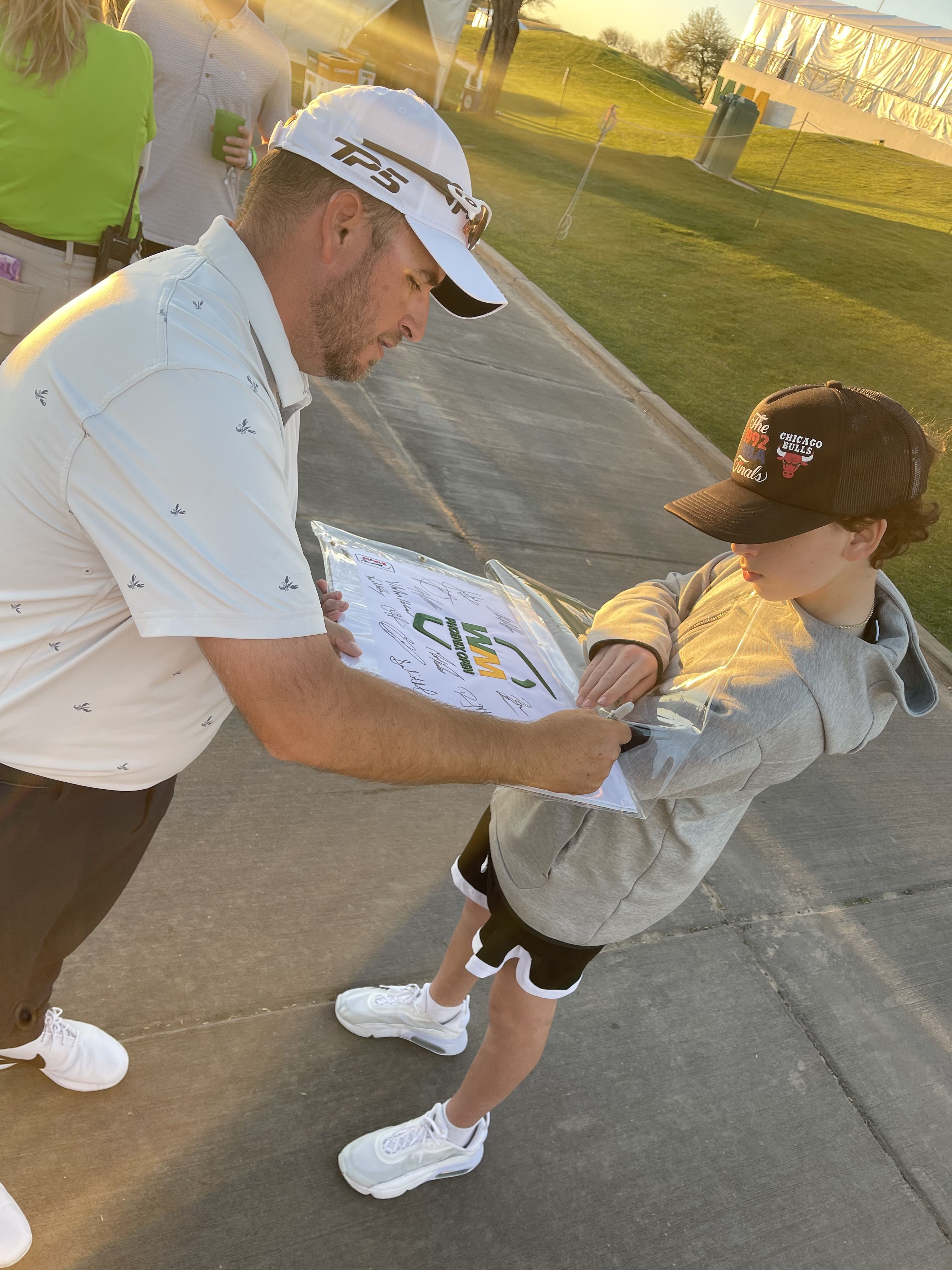 Michael Hopper, PGA, signs an autograph for a fan at the 2023 WM Phoenix Open.