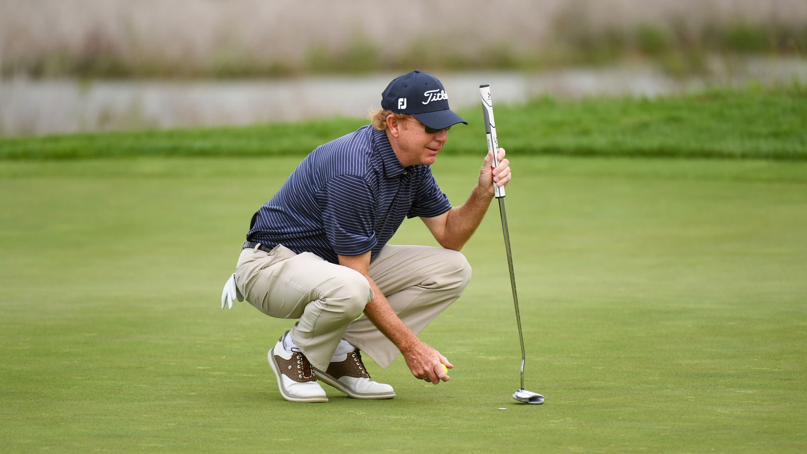 PGA Professional, Paul Claxton reads his putt on the 16th green during the first round of the 82nd KitchenAid Senior PGA Championship held at Harbor Shores Golf Club.