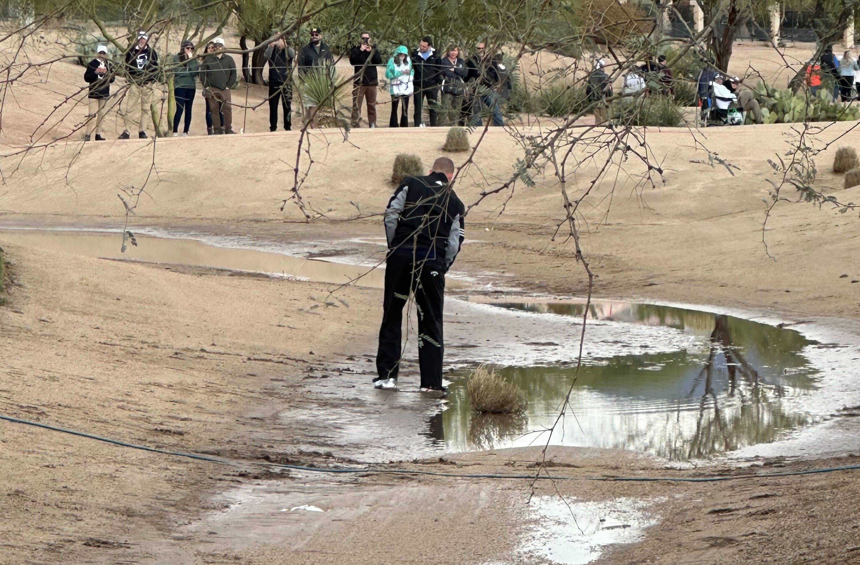 Daniel Berger in the mud on the par-5 third hole. 