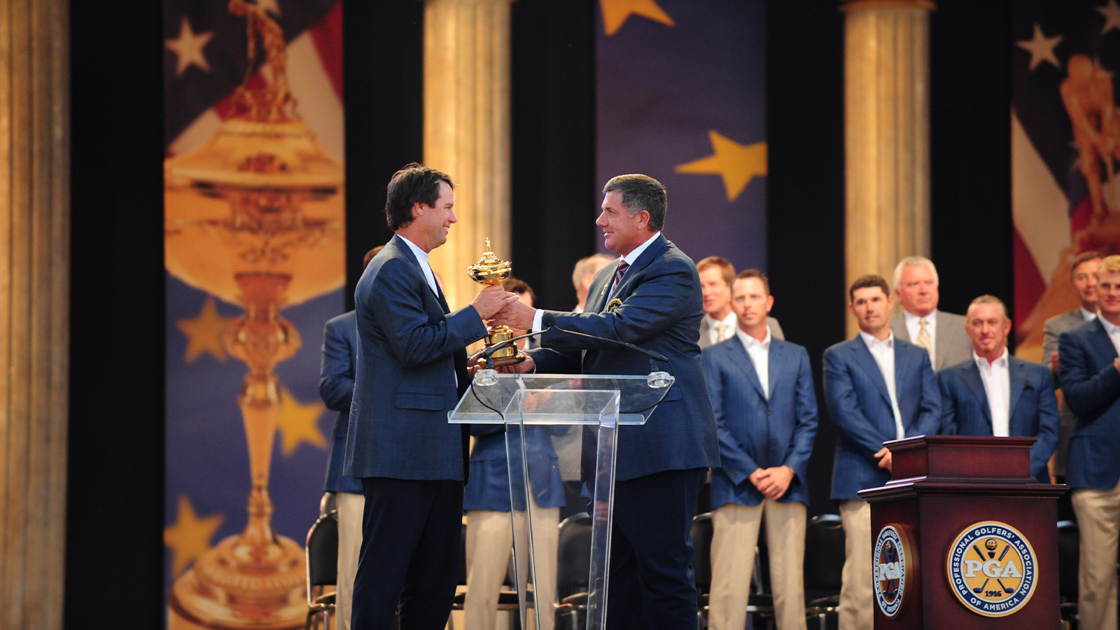 35th PGA President Brian Whitcomb (R) presents the Ryder Cup trophy to U.S. Ryder Cup Captain Paul Azinger (L) during the closing ceremony of the 37th Ryder Cup at Valhalla Golf Club in Louisville, Kentucky, USA, on Sunday, September 21, 2008. (Photo by Montana Pritchard/The PGA of America)
