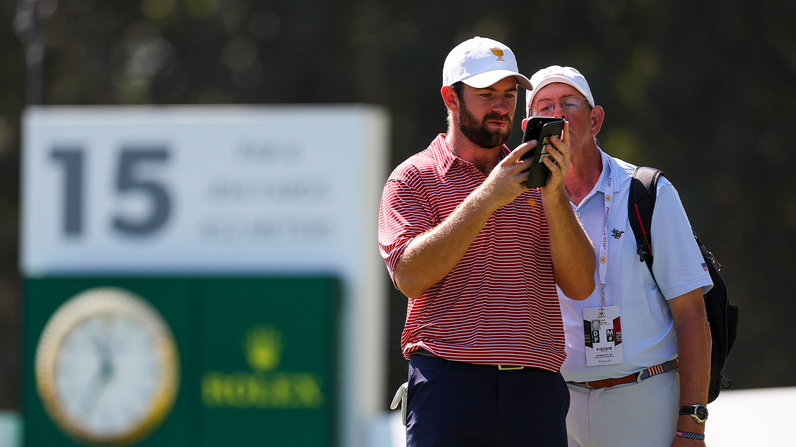 Cameron Young of the United States Team talks with his father Dave Young on the 15th tee during a practice round prior to the 2022 Presidents Cup at Quail Hollow Country Club on September 20, 2022 in Charlotte, North Carolina. (Photo by Rob Carr/Getty Images)