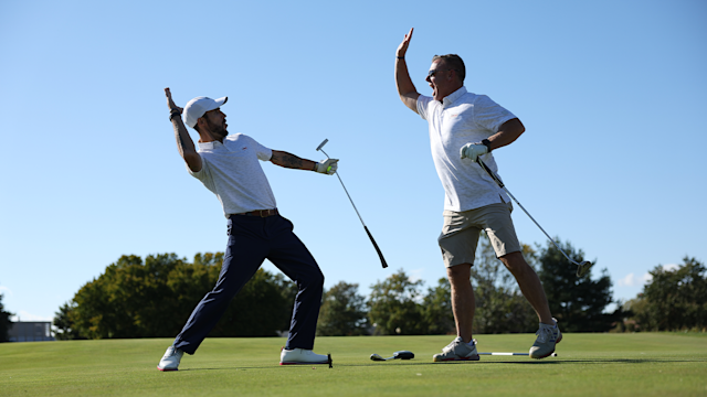 Colton Hensley high fives Troy Brin at the East Potomac Golf Links on October 14, 2022 in Washington, DC. (Photo by Scott Taetsch/PGA of America)