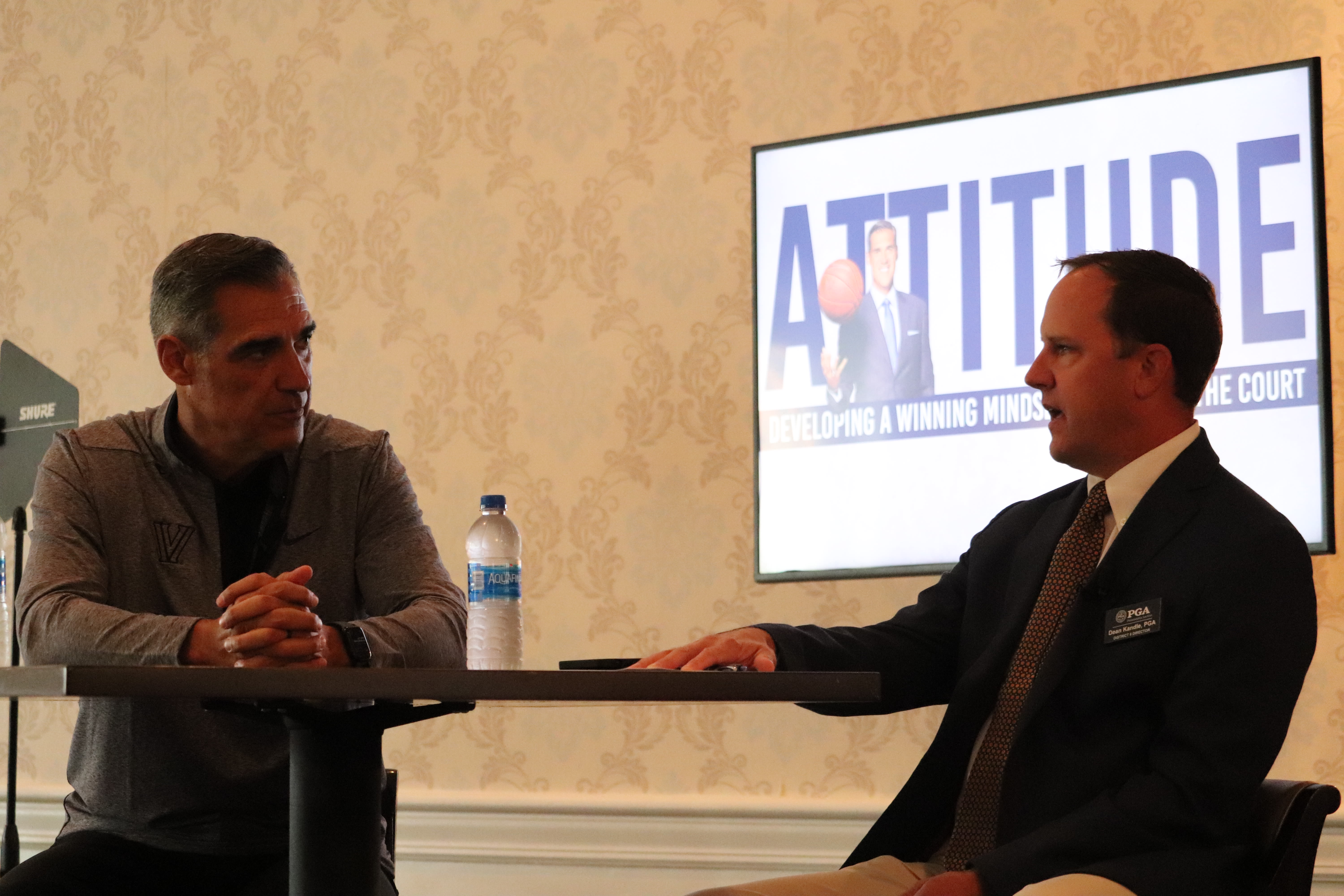 Kandle with former Villanova men's basketball coach Jay Wright during a seminar.