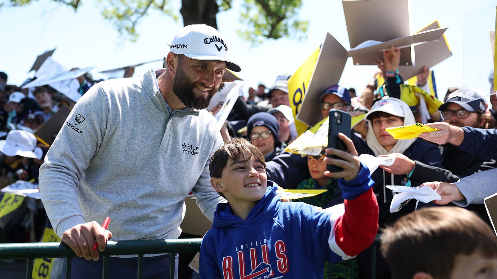 Jon Rahm poses for a selfie with a fan.