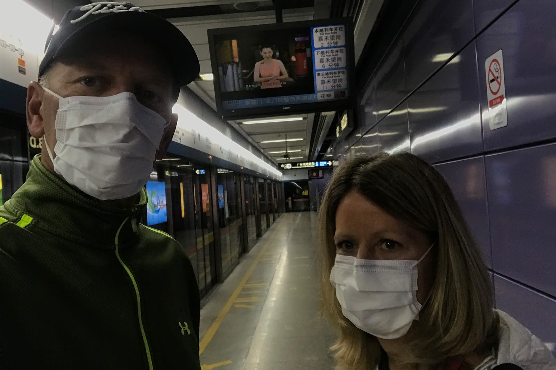 Doug and Karla Rohrbaugh wearing surgical masks in a train station in Guangzhou, China - Jan. 23, as they left for Thailand