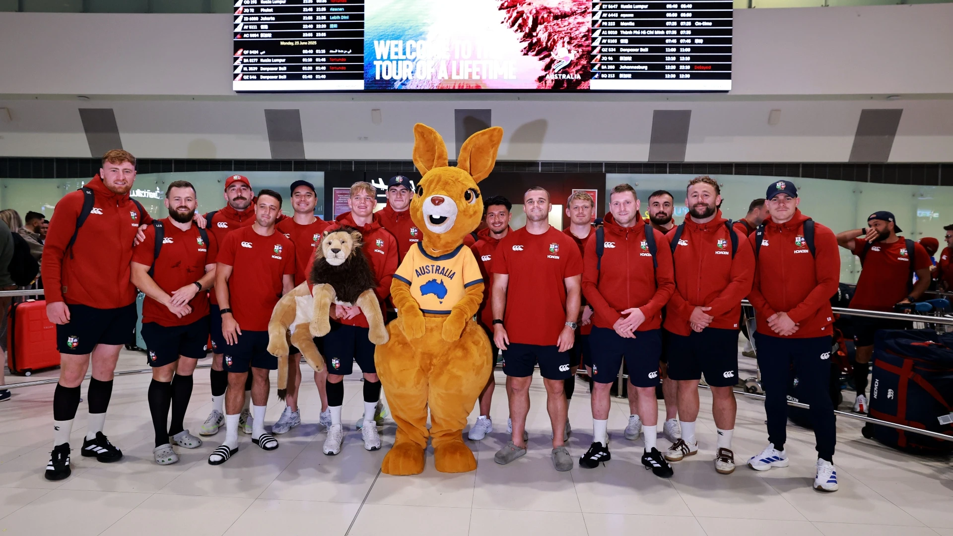 Players pose with Aus mascot