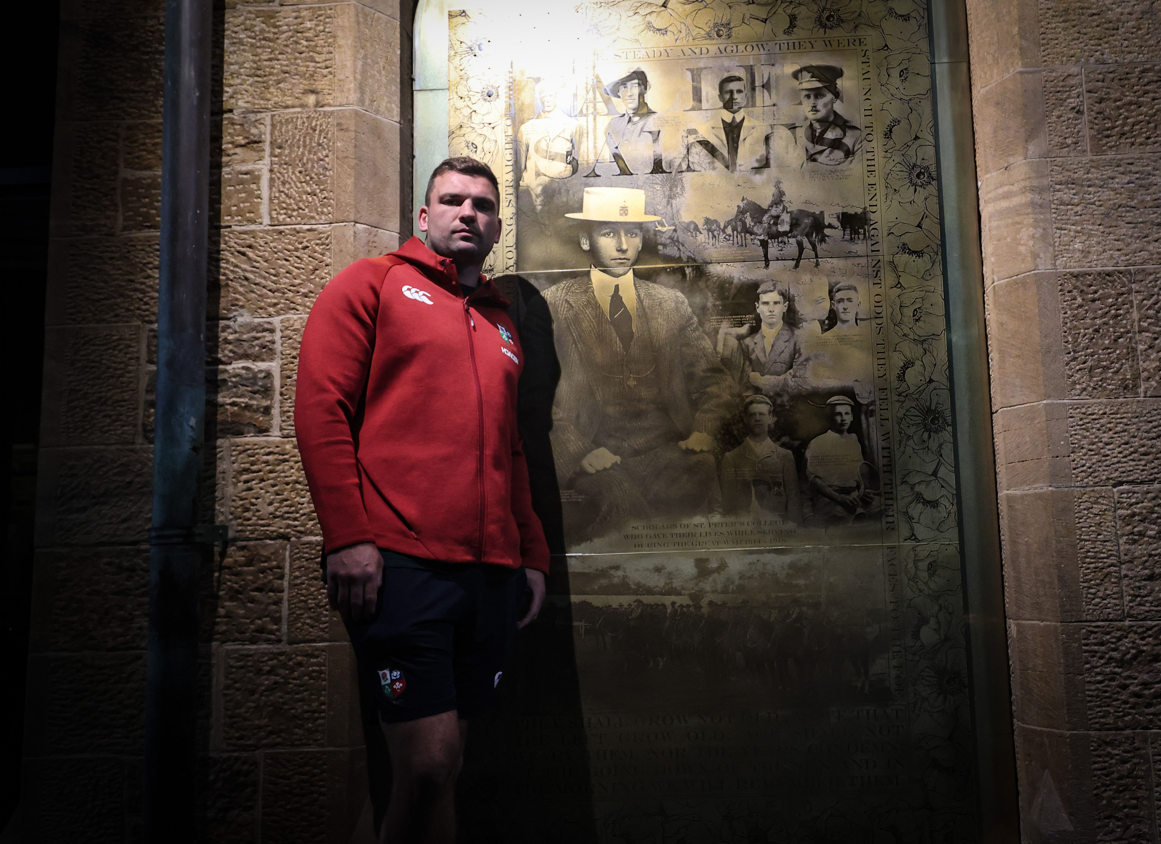 Tadhg Beirne stands in front of a ANZAC Memorial 