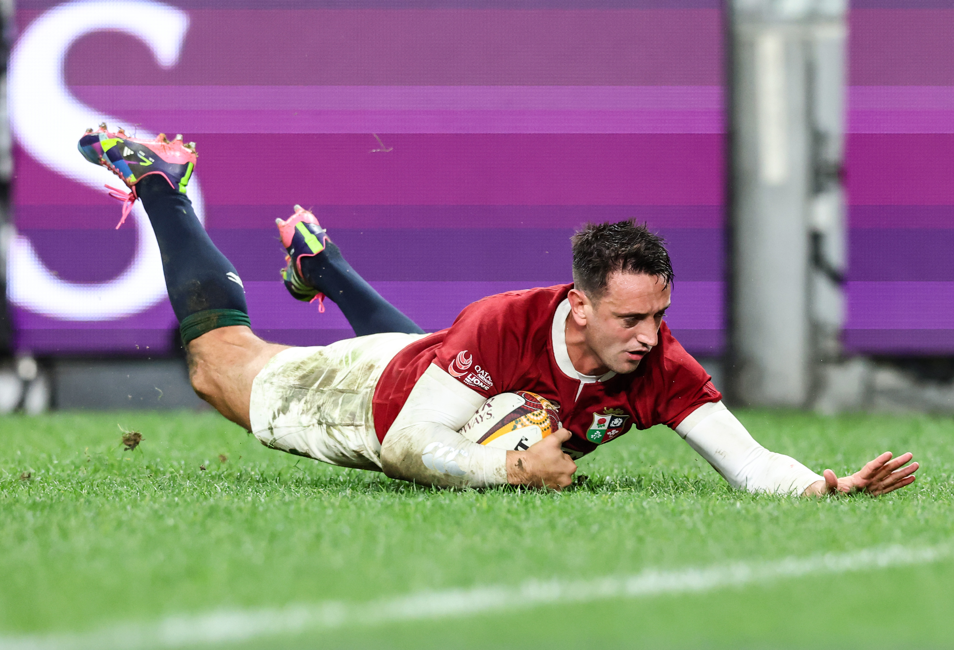 Alex Mitchell slides over against NSW Waratahs