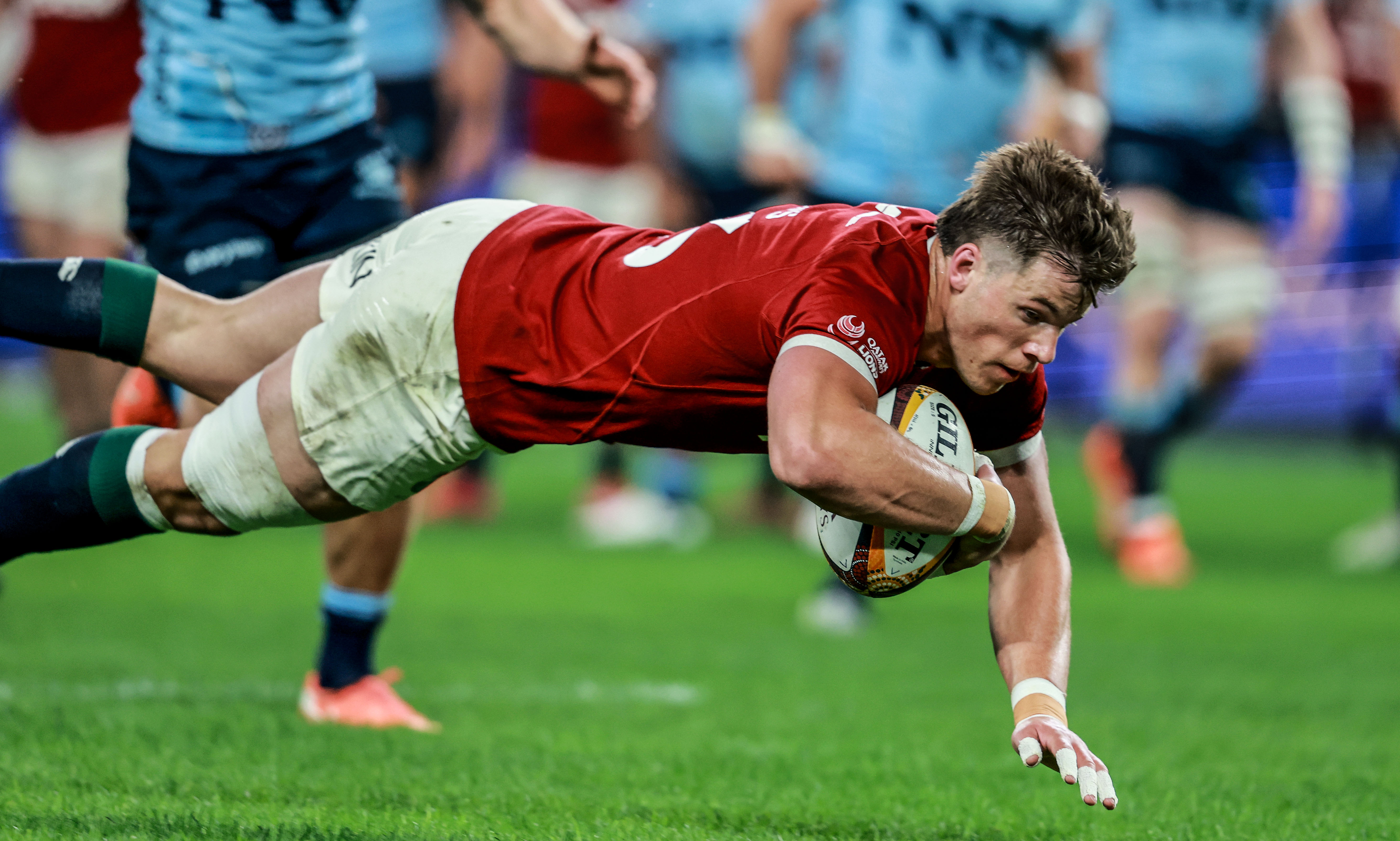 Huw Jones dives over for the Lions in Sydney