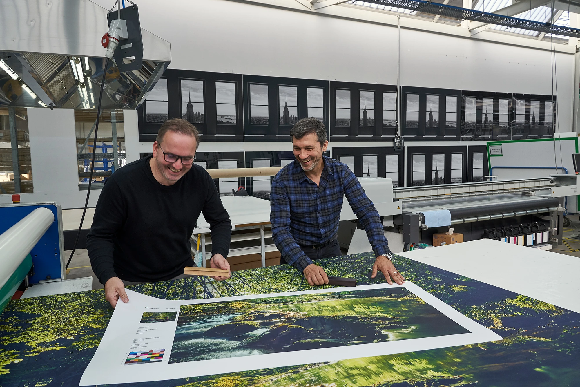 two men looking at a photo print