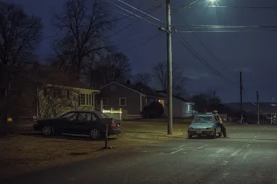  neighbourhood streets at night, with cars, street light.