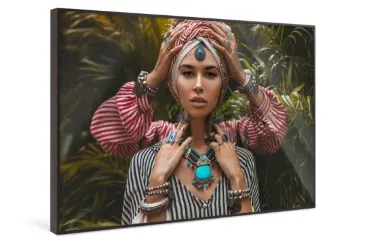 Four hands of two people wearing jewelry touch the head and neck of a person wearing a turquoise necklace.