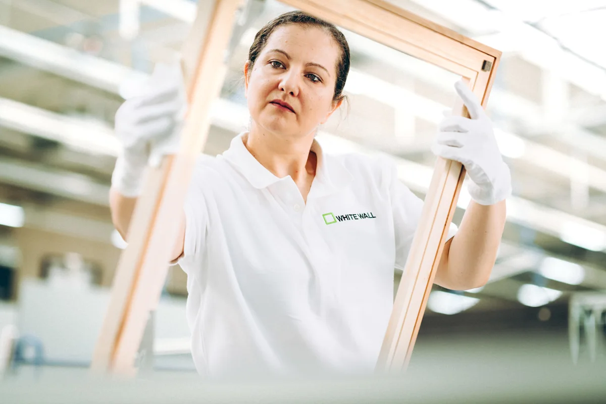 woman holding a wooden frame without image