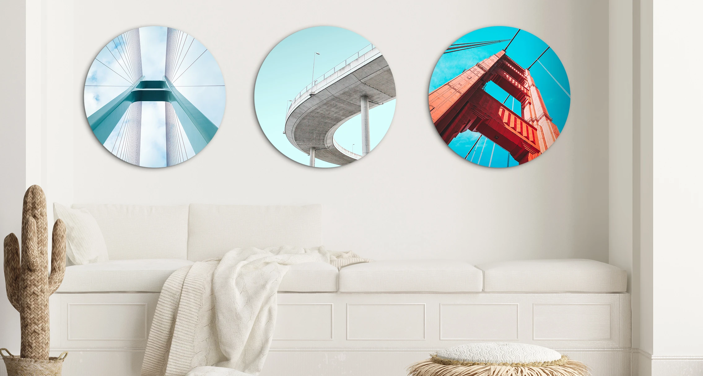 3 different round pictures with street bridges are hung next to each other on a wall. 