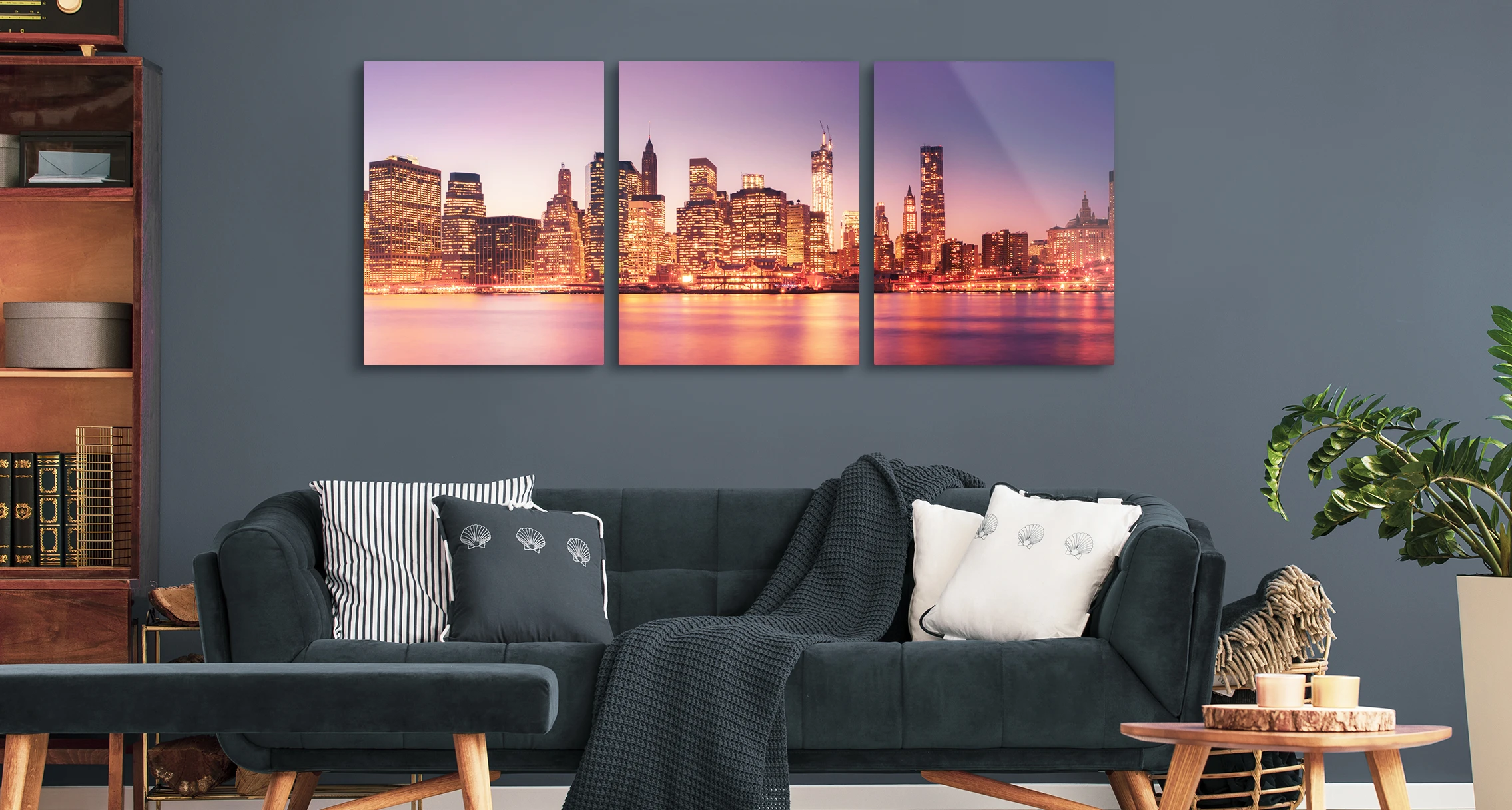 An evening long exposure of a skyline. The whole picture is divided into three parts that hang horizontally on the wall. 