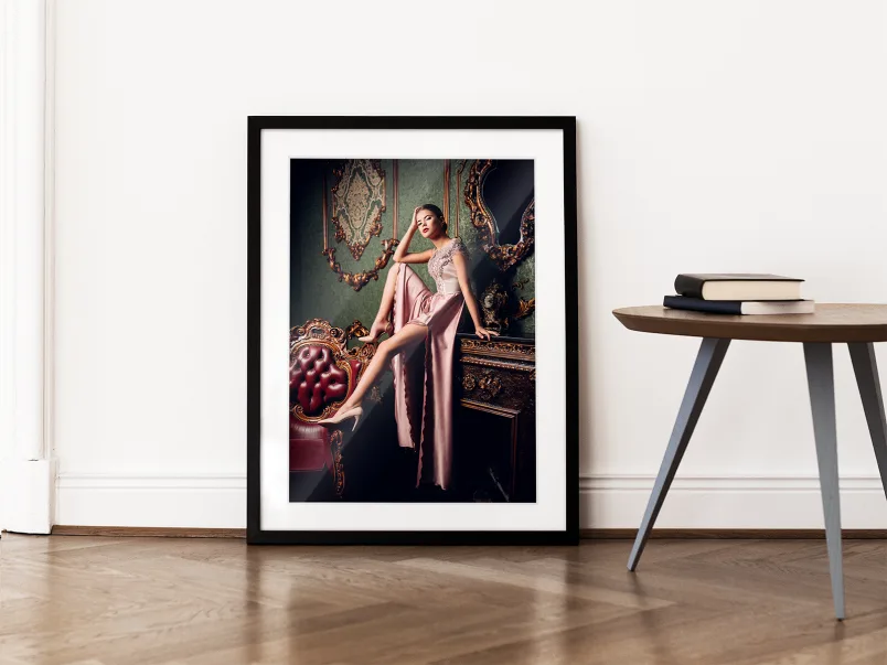 A woman has her portrait taken on a chest of drawers in a Solid Wood Frame With Passe-Partout leaning against a wall in a living room.