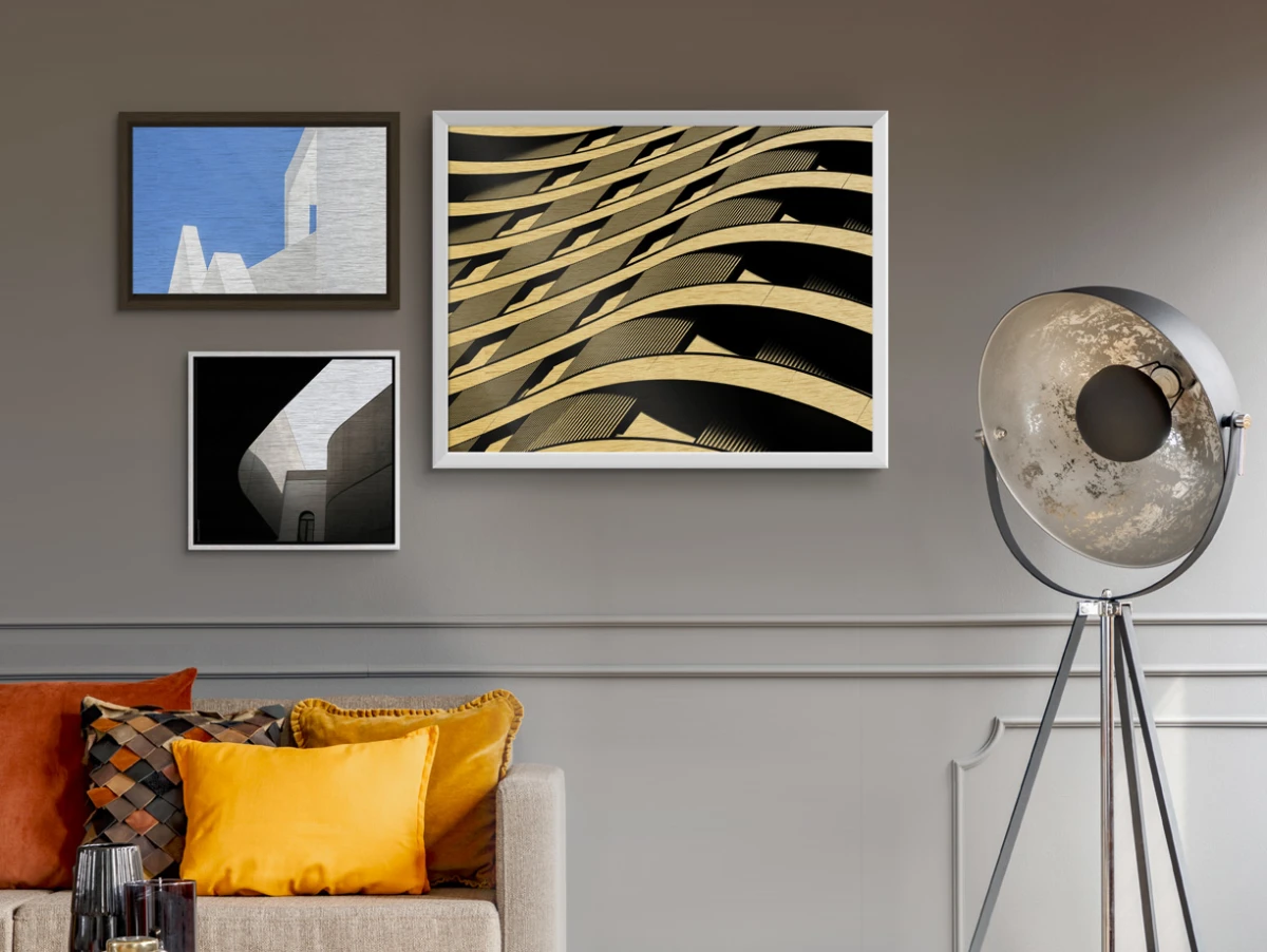 Several different motifs on Photo Print On Aluminum Backing with different frames hang on a wall in a living room.