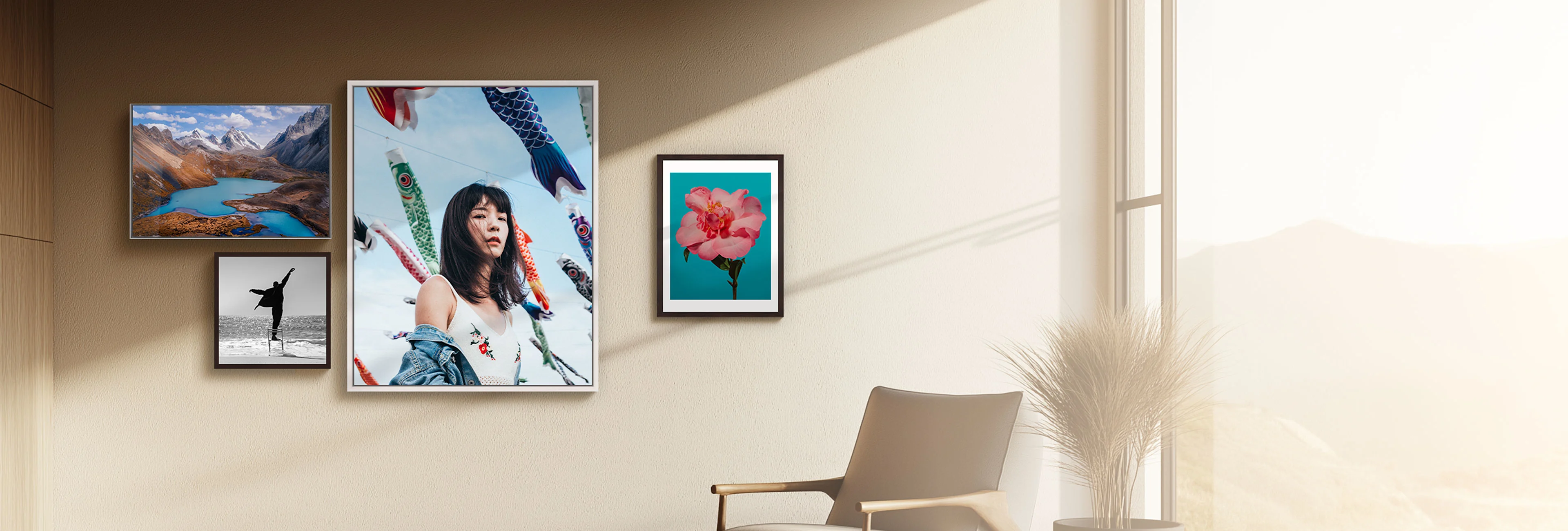 Gallery wall featuring framed artwork including mountain landscape with blue lake, silhouette dancer, portrait, and coral flowers on turquoise background