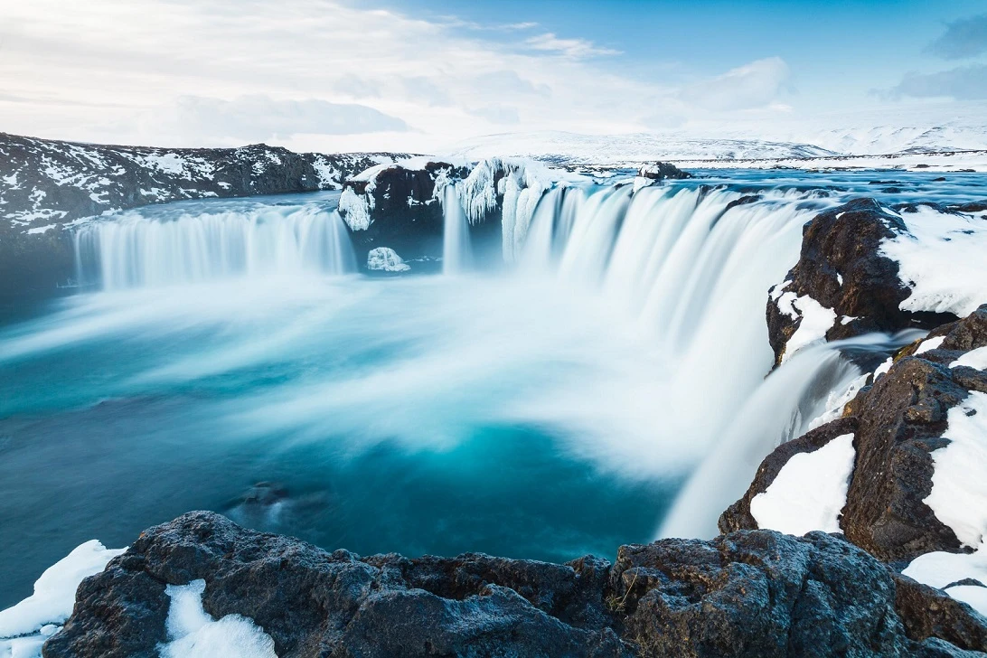 Waterfalls in icy landscape.