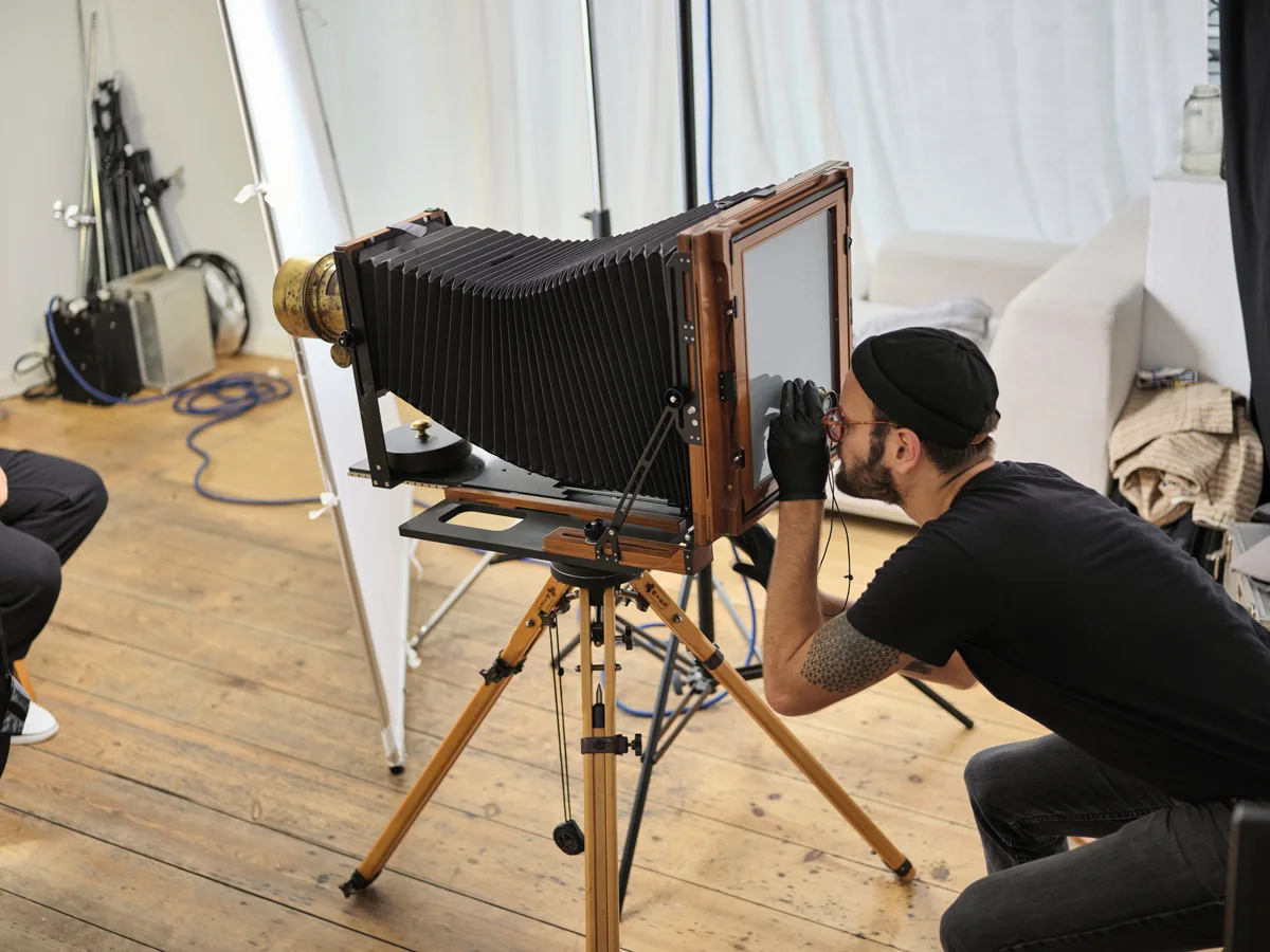 Maximilian Zeitler taking pictures with an old camera.