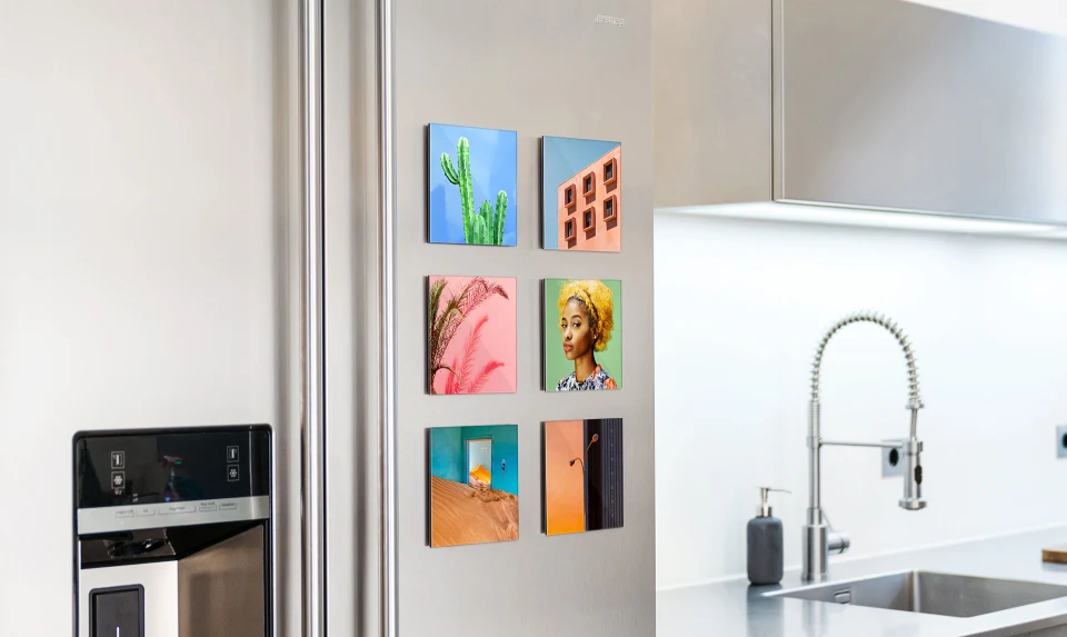 multiple whitewall mini acrylic prints hanging on a fridge.