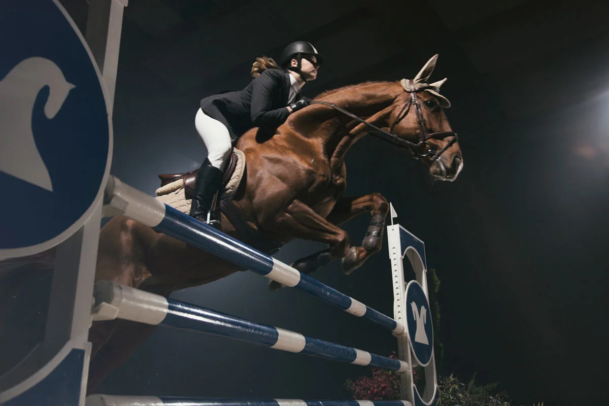 woman jumping with ther horse.