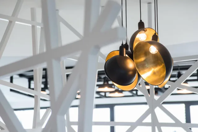 round lamps hanging in a white room.