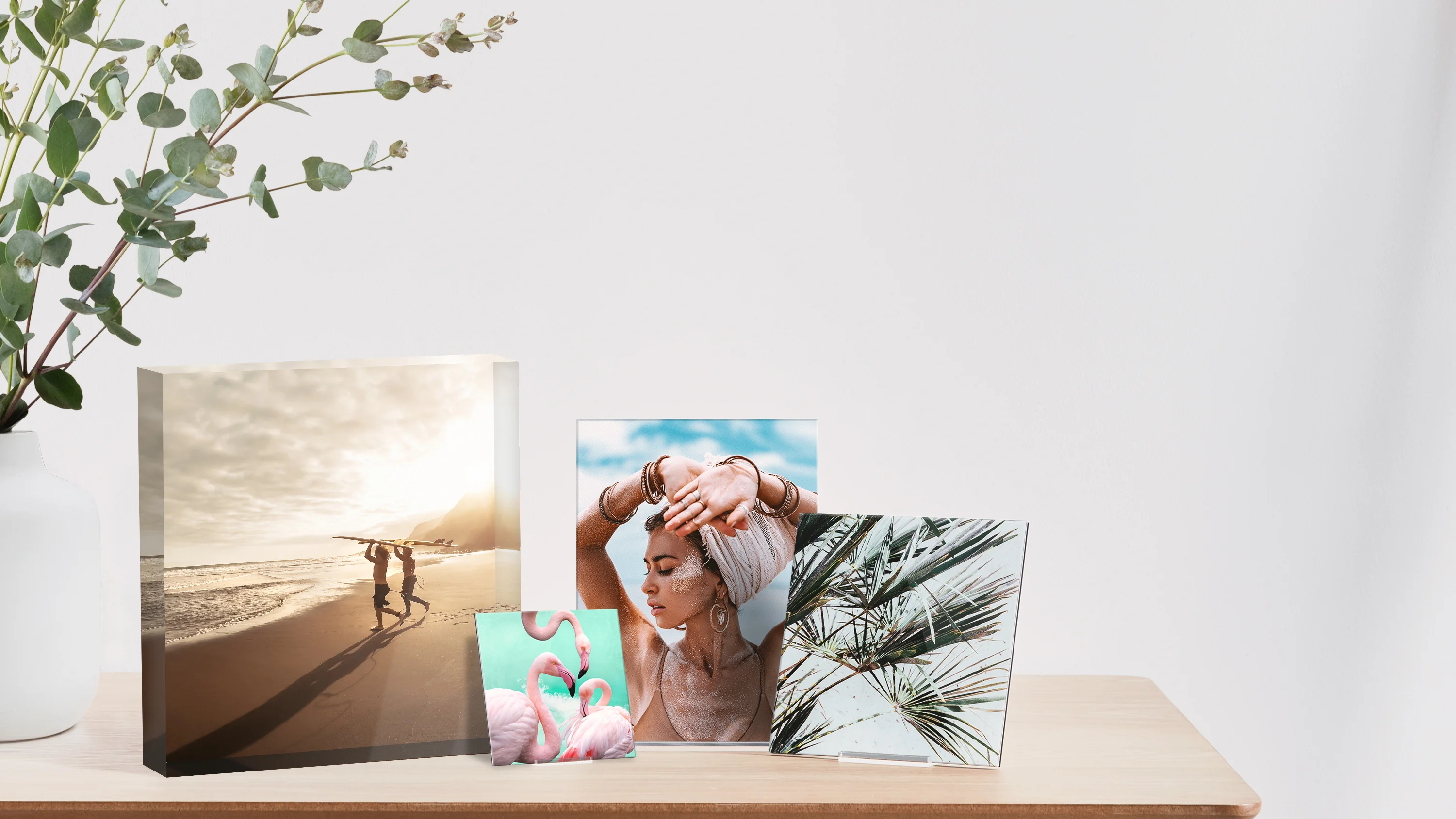 acrylic photo block, acrylic glass stand and whitewall mini standing on a desk.