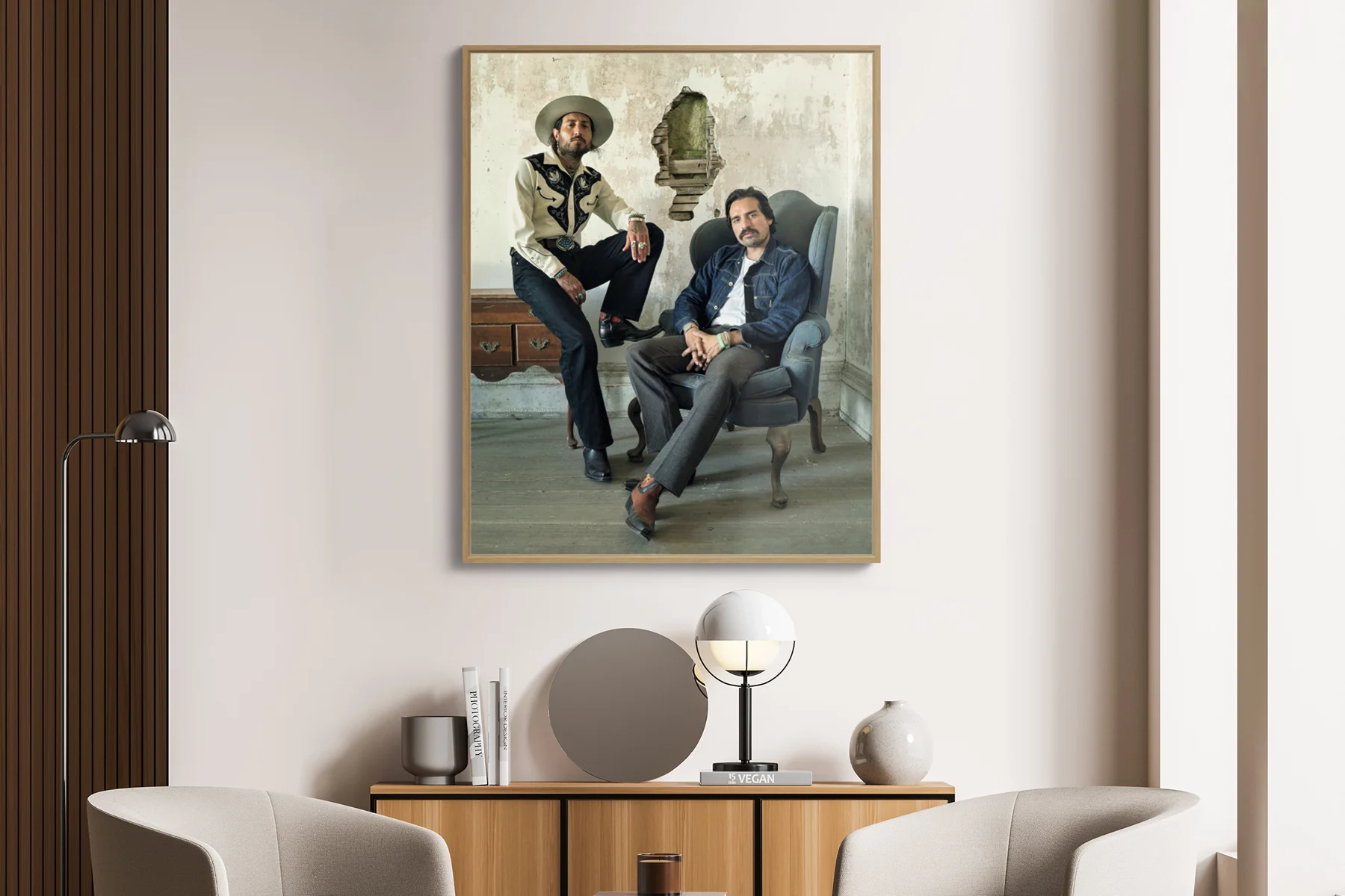 portrait of two men dressed with southern style clothing sitting on a table and an armchair.