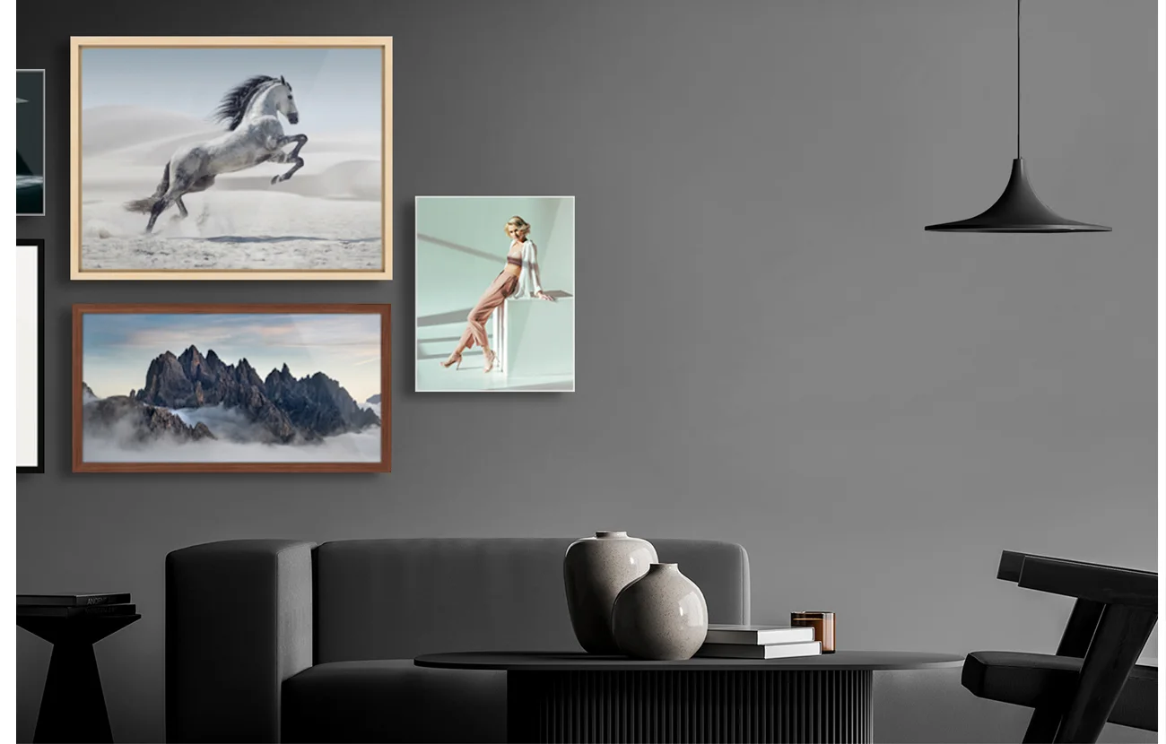 Various, differently framed prints hang on the wall.