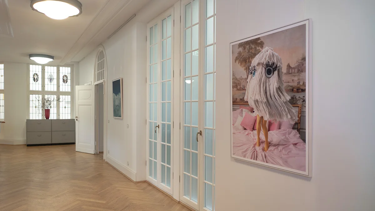 A bright law-firm hallway with herringbone floors displaying a surreal artwork of a mop-headed figure with cartoon eyes on a pink bed.