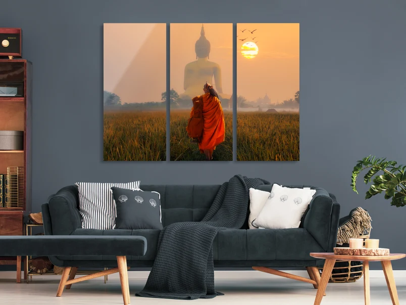 A monk is standing in front of a huge Buddha statue. The whole picture is divided into three parts. 