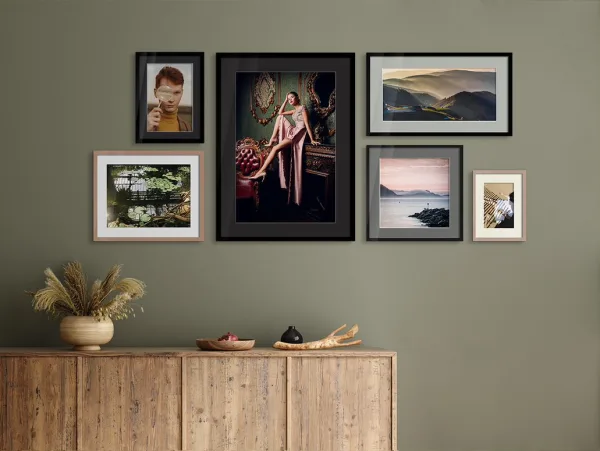 Several different motifs framed in a  Solid Wood Frame With Passe-Partout on a wall in a living room.